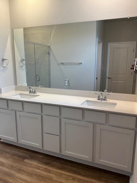 1015 Vista View Dr Unit 101, Georgetown, TX 78626 - full bathroom with a shower stall, double vanity, and wood finished floors