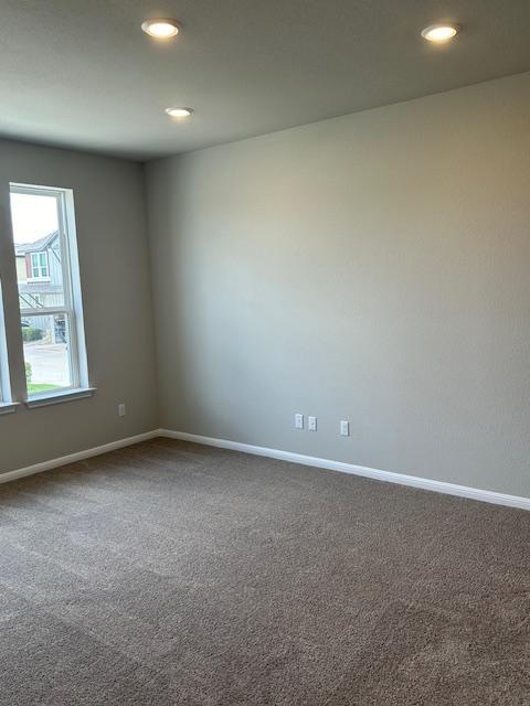 1015 Vista View Dr Unit 101, Georgetown, TX 78626 - empty room with dark colored carpet, baseboards, and recessed lighting