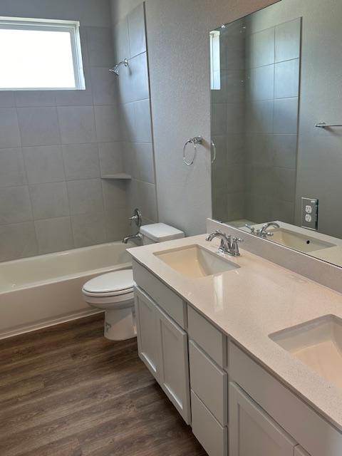 1015 Vista View Dr Unit 101, Georgetown, TX 78626 - full bath featuring toilet, wood finished floors, washtub / shower combination, and double vanity