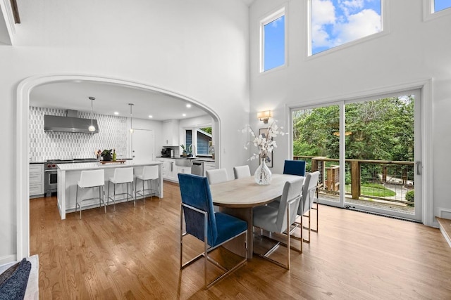 4107 Jefferson St, Austin, TX 78731 - dining space with light wood-style floors, a high ceiling, recessed lighting, and arched walkways