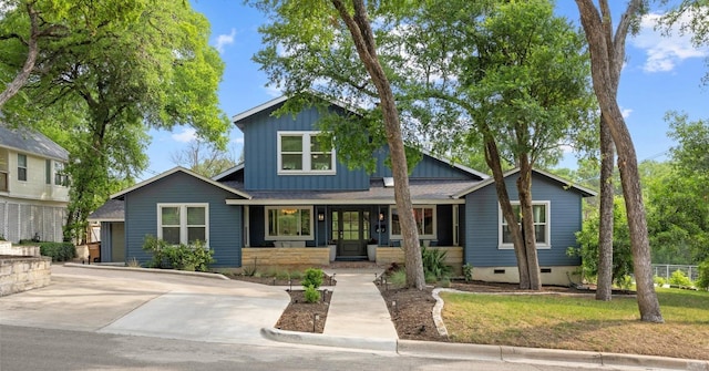 4107 Jefferson St, Austin, TX 78731 - view of front of house with a porch, board and batten siding, and crawl space