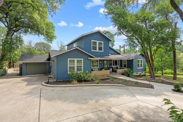 4107 Jefferson St, Austin, TX 78731 - view of front of home with driveway, covered porch, board and batten siding, and an attached garage