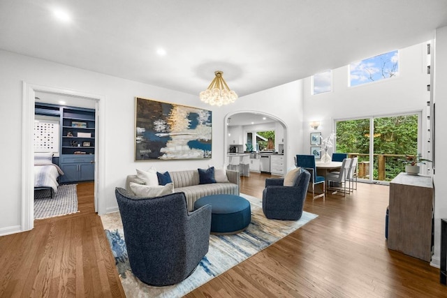 4107 Jefferson St, Austin, TX 78731 - living area featuring arched walkways, wood finished floors, a chandelier, and recessed lighting