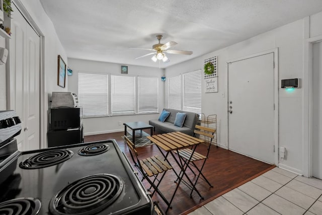 1010 W 23rd St Unit 16, Austin, TX 78705 - tiled living room featuring ceiling fan and baseboards