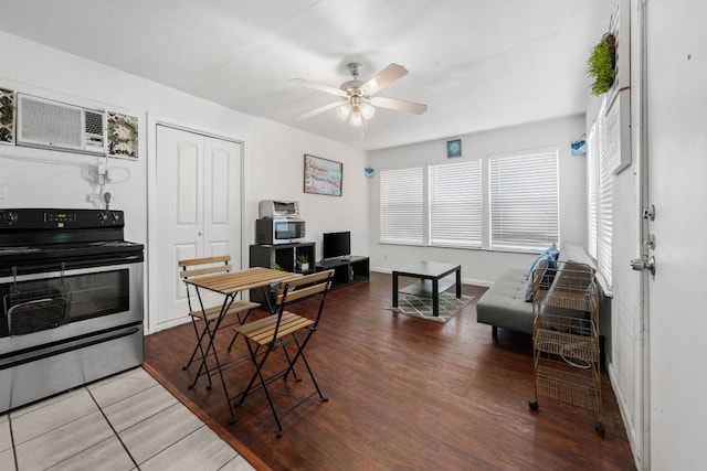 1010 W 23rd St Unit 16, Austin, TX 78705 - dining area featuring a ceiling fan, a wall mounted air conditioner, baseboards, and wood finished floors