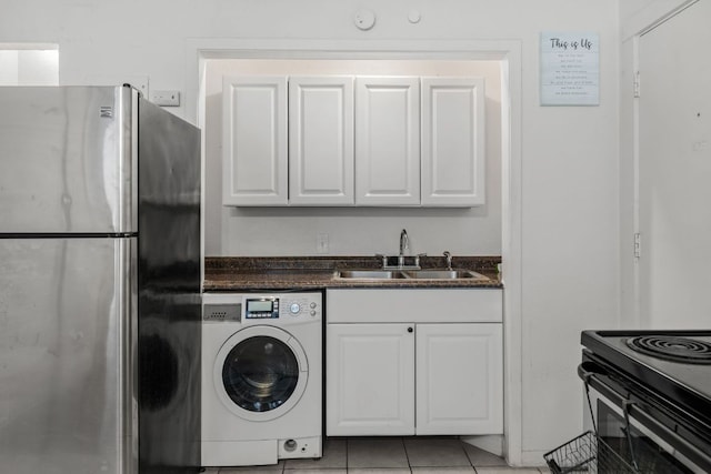 1010 W 23rd St Unit 16, Austin, TX 78705 - laundry area with washer / clothes dryer and light tile patterned floors