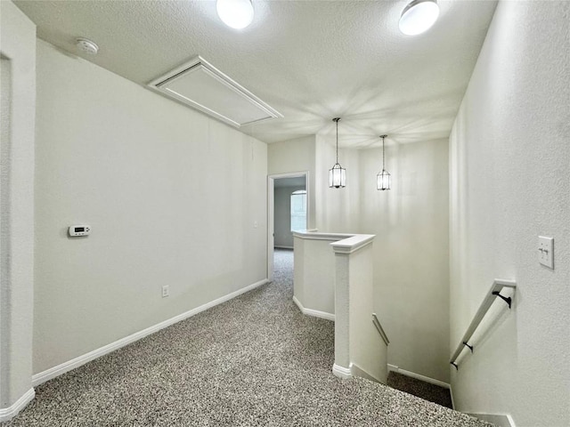 513 N Heatherwilde Blvd, Pflugerville, TX 78660 - corridor featuring an upstairs landing, attic access, carpet floors, baseboards, and a textured ceiling