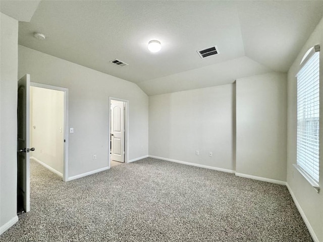 513 N Heatherwilde Blvd, Pflugerville, TX 78660 - unfurnished bedroom with carpet flooring, lofted ceiling, baseboards, and multiple windows