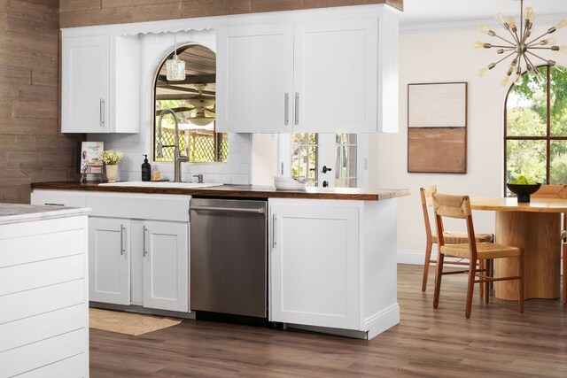 2403 Little John Ln, Austin, TX 78704 - kitchen with stainless steel dishwasher, a sink, dark wood-style flooring, backsplash, and white cabinetry