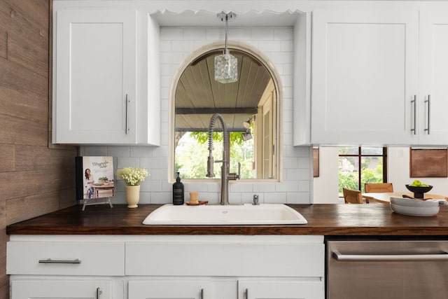 2403 Little John Ln, Austin, TX 78704 - kitchen with dishwasher, a sink, wood counters, and decorative backsplash