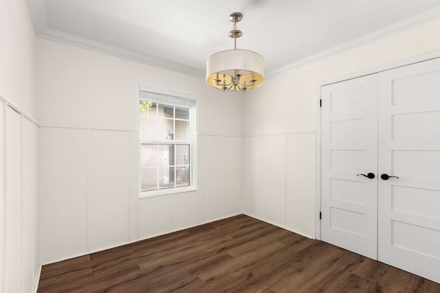 2403 Little John Ln, Austin, TX 78704 - unfurnished room featuring a chandelier, dark wood-type flooring, crown molding, wainscoting, and a decorative wall