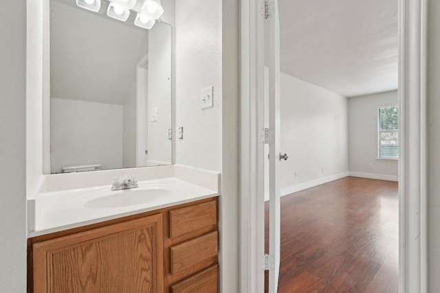 100 Blanco Woods Blvd, Elgin, TX 78621 - half bath with vanity, wood finished floors, and baseboards