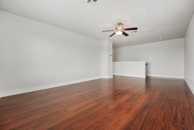 100 Blanco Woods Blvd, Elgin, TX 78621 - unfurnished living room with ceiling fan, dark wood-type flooring, and baseboards