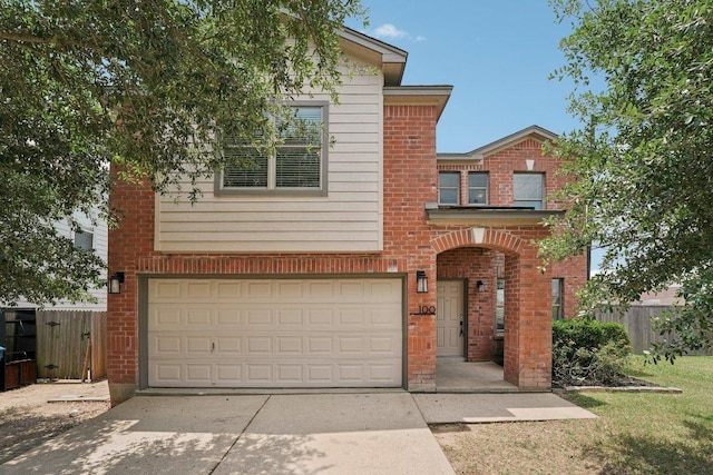 100 Blanco Woods Blvd, Elgin, TX 78621 - view of front of home featuring an attached garage, driveway, and brick siding