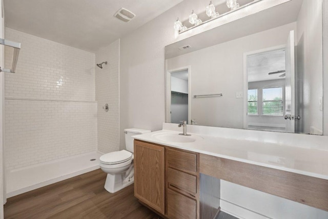 100 Blanco Woods Blvd, Elgin, TX 78621 - bathroom with toilet, wood finished floors, tiled shower, and vanity