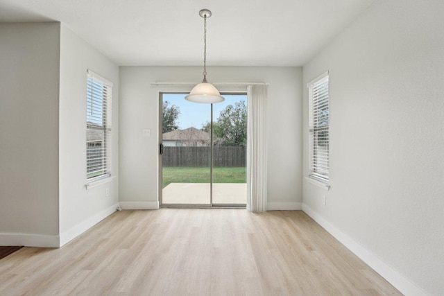 100 Blanco Woods Blvd, Elgin, TX 78621 - unfurnished dining area featuring light wood finished floors, healthy amount of natural light, and baseboards