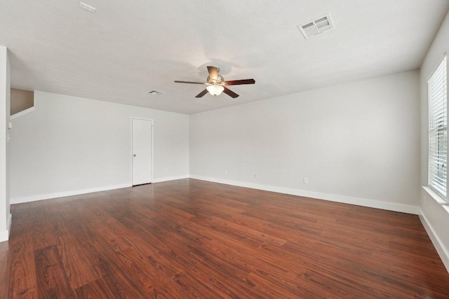 100 Blanco Woods Blvd, Elgin, TX 78621 - empty room with ceiling fan, dark wood-style floors, plenty of natural light, and baseboards