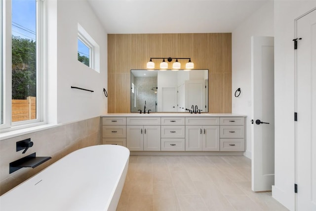 402 Fife Dr, Spicewood, TX 78669 - full bathroom featuring double vanity, a shower stall, a freestanding bath, tile patterned flooring, and wooden walls