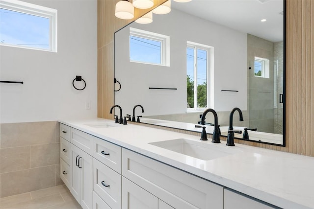402 Fife Dr, Spicewood, TX 78669 - full bathroom with double vanity, healthy amount of natural light, a stall shower, tile patterned flooring, and recessed lighting