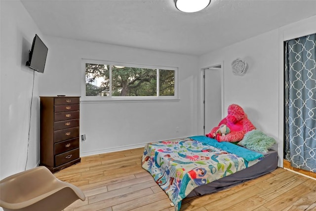 122 W Sierra Cir, San Marcos, TX 78666 - bedroom with wood finished floors and baseboards
