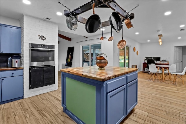 122 W Sierra Cir, San Marcos, TX 78666 - kitchen featuring wood counters, blue cabinets, recessed lighting, light wood-style flooring, and double oven