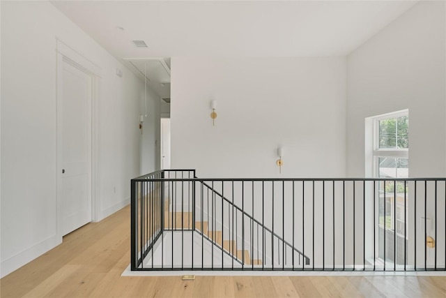 113 Nelray Blvd Unit 1, Austin, TX 78751 - hallway featuring attic access, wood finished floors, an upstairs landing, and baseboards
