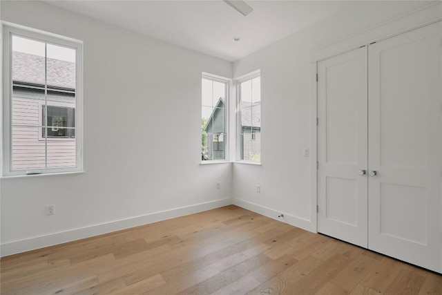 113 Nelray Blvd Unit 1, Austin, TX 78751 - unfurnished bedroom with light wood-style flooring, multiple windows, and baseboards