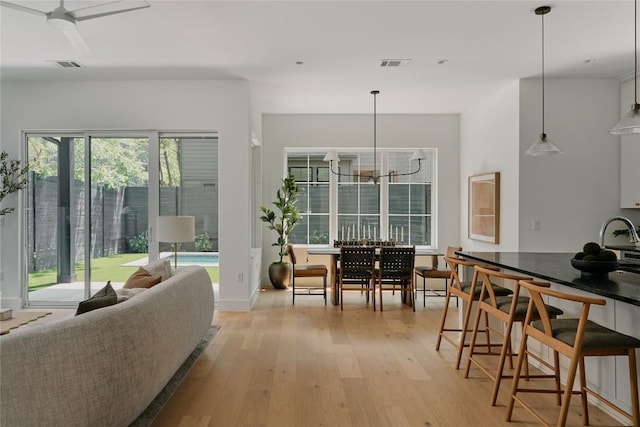 113 Nelray Blvd Unit 1, Austin, TX 78751 - living area with light wood-type flooring, a chandelier, and baseboards