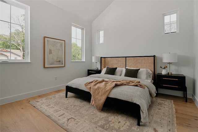 113 Nelray Blvd Unit 1, Austin, TX 78751 - bedroom featuring high vaulted ceiling, wood finished floors, and baseboards