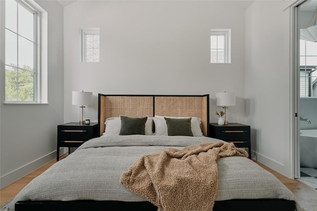113 Nelray Blvd Unit 1, Austin, TX 78751 - bedroom featuring multiple windows, wood finished floors, and a high ceiling