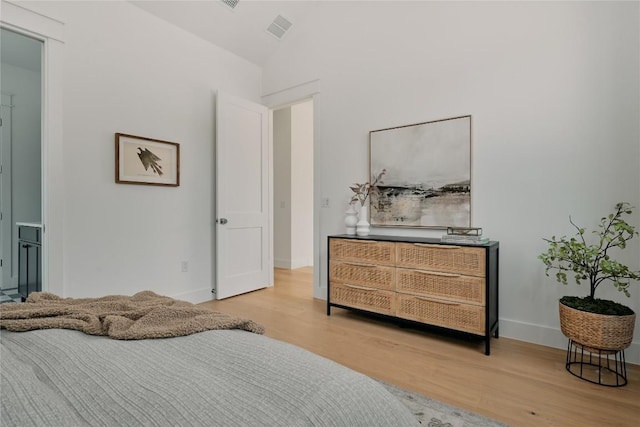 113 Nelray Blvd Unit 1, Austin, TX 78751 - bedroom with wood finished floors, lofted ceiling, and baseboards