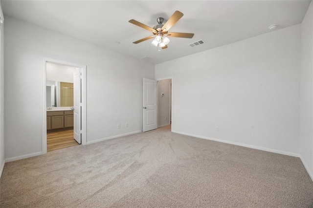 500 Municipal Dr Unit 102, Leander, TX 78641 - unfurnished bedroom with light colored carpet, baseboards, and ensuite bath