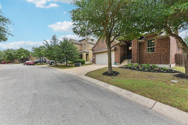 190 Stone View Trl, Austin, TX 78737 - view of property hidden behind natural elements with concrete driveway, a garage, and brick siding