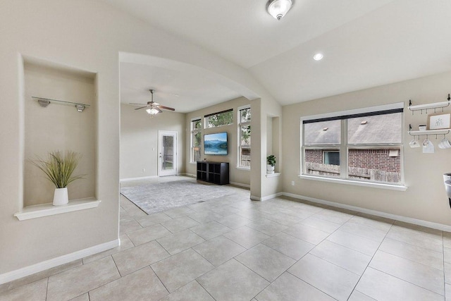 190 Stone View Trl, Austin, TX 78737 - unfurnished living room with arched walkways, ceiling fan, lofted ceiling, and tile patterned floors