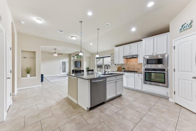 190 Stone View Trl, Austin, TX 78737 - kitchen with stainless steel appliances, backsplash, under cabinet range hood, white cabinets, and dark stone countertops