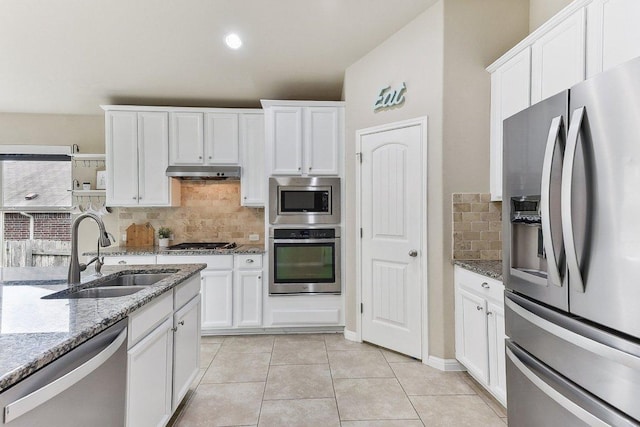 190 Stone View Trl, Austin, TX 78737 - kitchen featuring stainless steel appliances, under cabinet range hood, white cabinets, and decorative backsplash