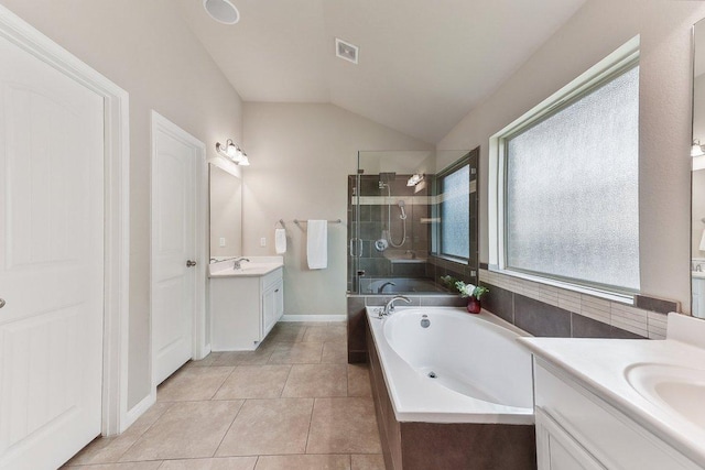 190 Stone View Trl, Austin, TX 78737 - full bath with a stall shower, two vanities, a garden tub, lofted ceiling, and tile patterned floors