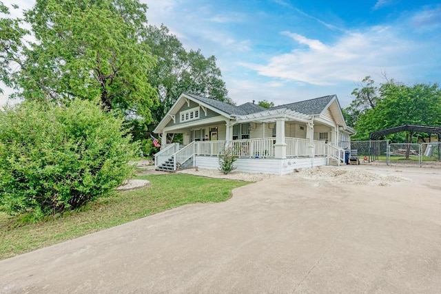 340 Ackerman St, Rockdale, TX 76567 - view of front of house featuring a porch, driveway, a detached carport, and a gate