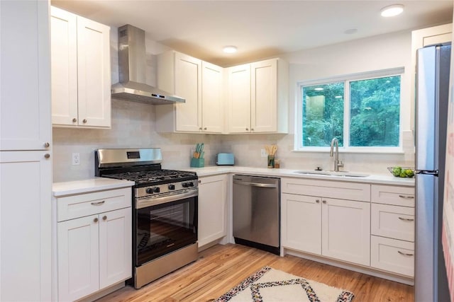 3801 Wilson St, Austin, TX 78704 - kitchen with stainless steel appliances, wall chimney range hood, a sink, light countertops, and recessed lighting