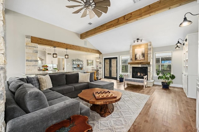 1011 County Road 149, Georgetown, TX 78626 - living room with a ceiling fan, light wood finished floors, and a fireplace
