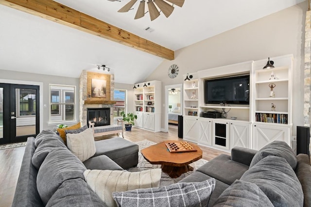 1011 County Road 149, Georgetown, TX 78626 - living room featuring a ceiling fan, light wood-style flooring, and a stone fireplace