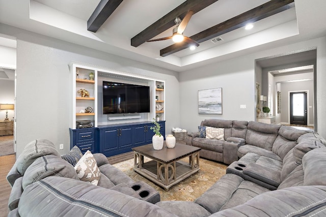 509 Leon Loop, Liberty Hill, TX 78642 - living room featuring a ceiling fan, beamed ceiling, and a raised ceiling