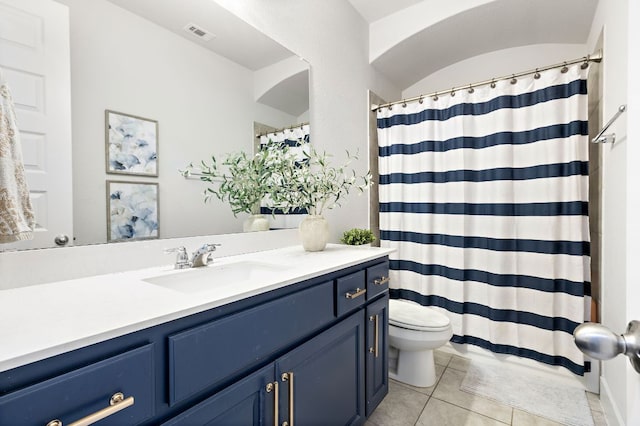 509 Leon Loop, Liberty Hill, TX 78642 - full bathroom featuring toilet, vanity, tile patterned flooring, and curtained shower