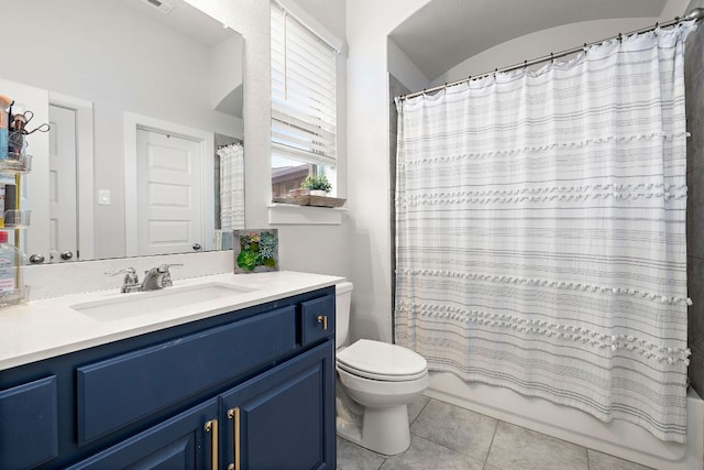 509 Leon Loop, Liberty Hill, TX 78642 - bathroom with tile patterned floors, toilet, vanity, and shower / bath combo with shower curtain