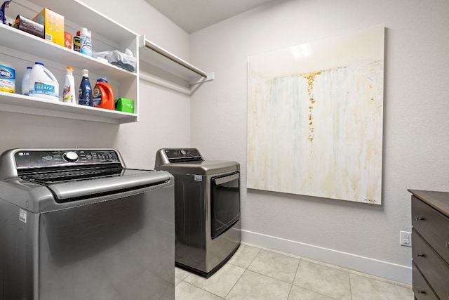 509 Leon Loop, Liberty Hill, TX 78642 - laundry room featuring separate washer and dryer, baseboards, and light tile patterned floors