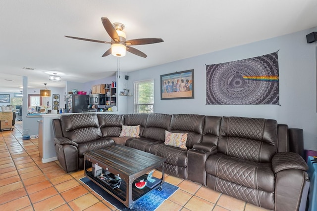 101 Texas Ash Cv, Manchaca, TX 78652 - living area featuring light tile patterned floors and a ceiling fan