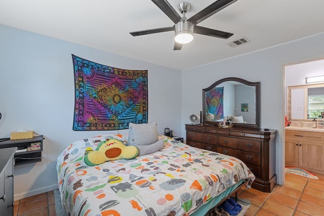 101 Texas Ash Cv, Manchaca, TX 78652 - bedroom with light tile patterned flooring, ensuite bathroom, a ceiling fan, and baseboards