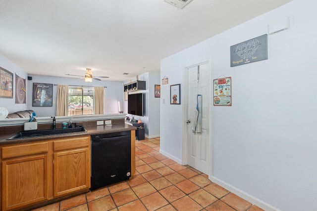 101 Texas Ash Cv, Manchaca, TX 78652 - kitchen with black dishwasher, a sink, dark countertops, light tile patterned floors, and ceiling fan