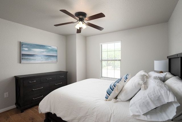 1526 Bonnyview Dr, Canyon Lake, TX 78133 - bedroom featuring dark wood-style flooring, baseboards, and a ceiling fan