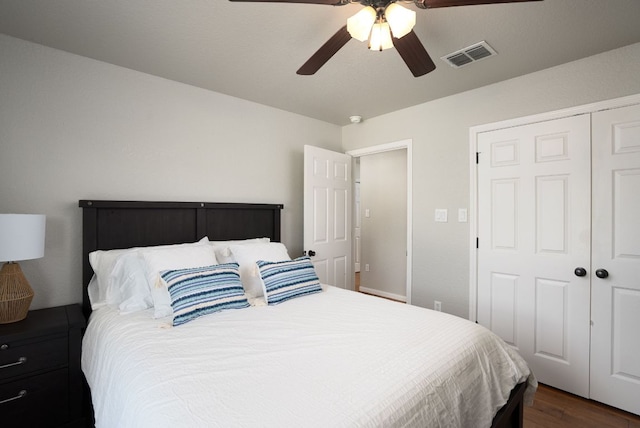 1526 Bonnyview Dr, Canyon Lake, TX 78133 - bedroom with a closet, dark wood-style flooring, and a ceiling fan